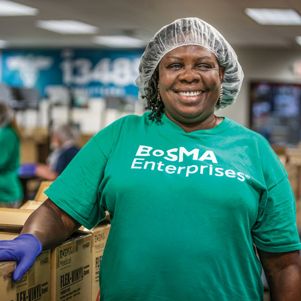 Employee smiling inside of fulfillment center