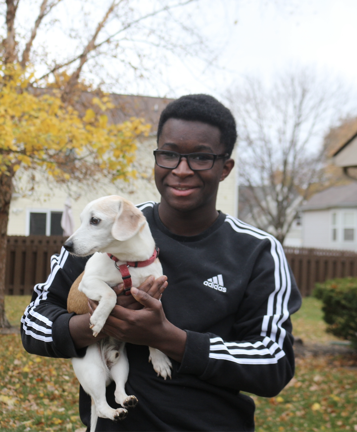 Dan Nanista holding his dog outside