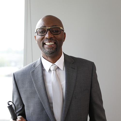 A man in a suite smiling at the camera