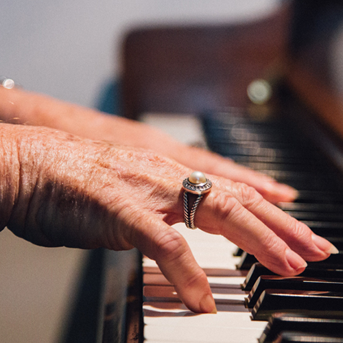 woman's hands playing piano