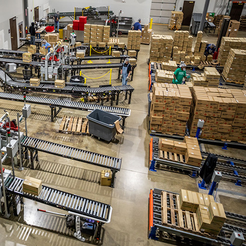 Overhead shot of warehouse conveyors and boxes of products.