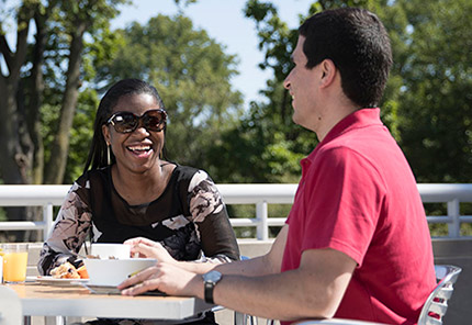 man and woman enjoying lunch outside