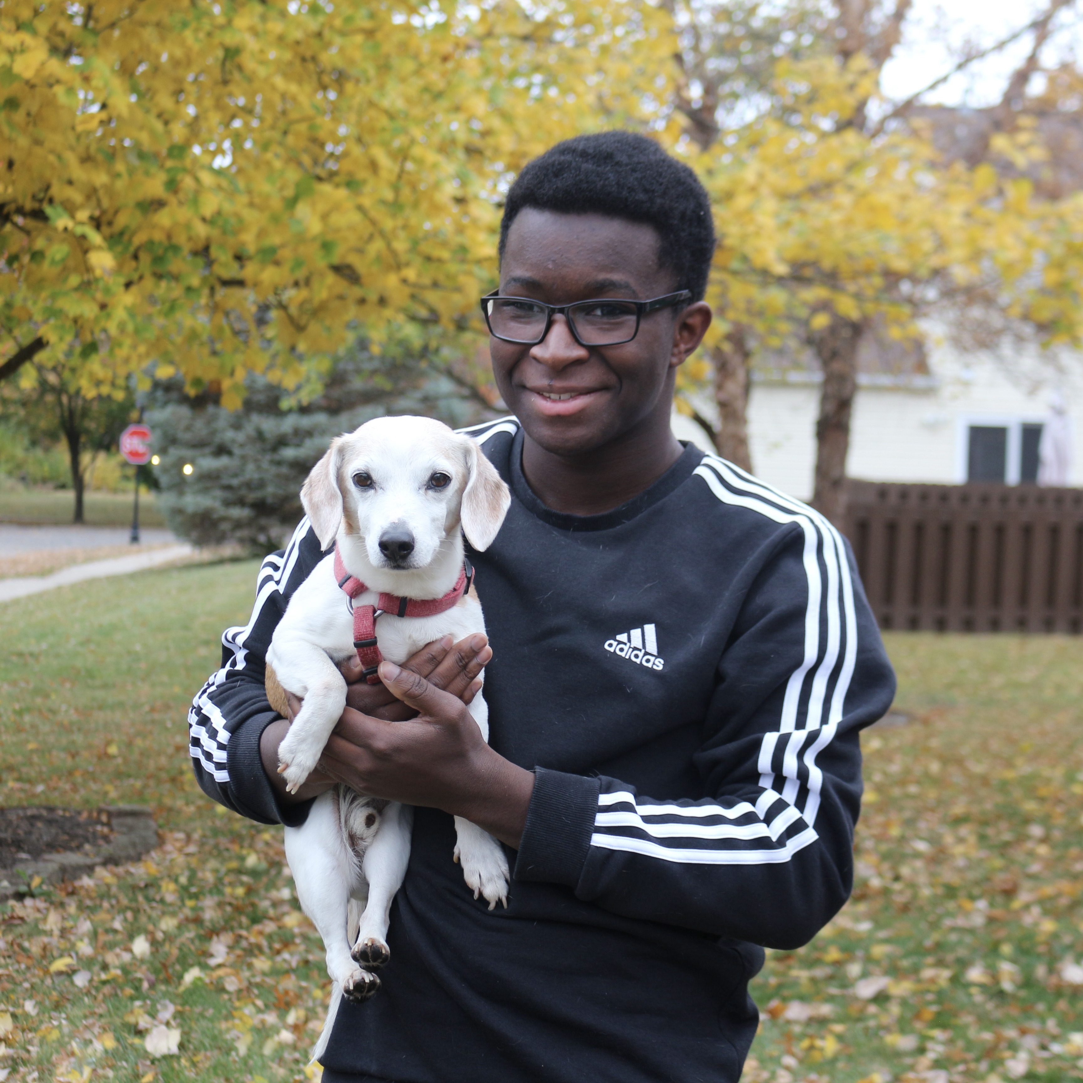 Man holding a dog outside