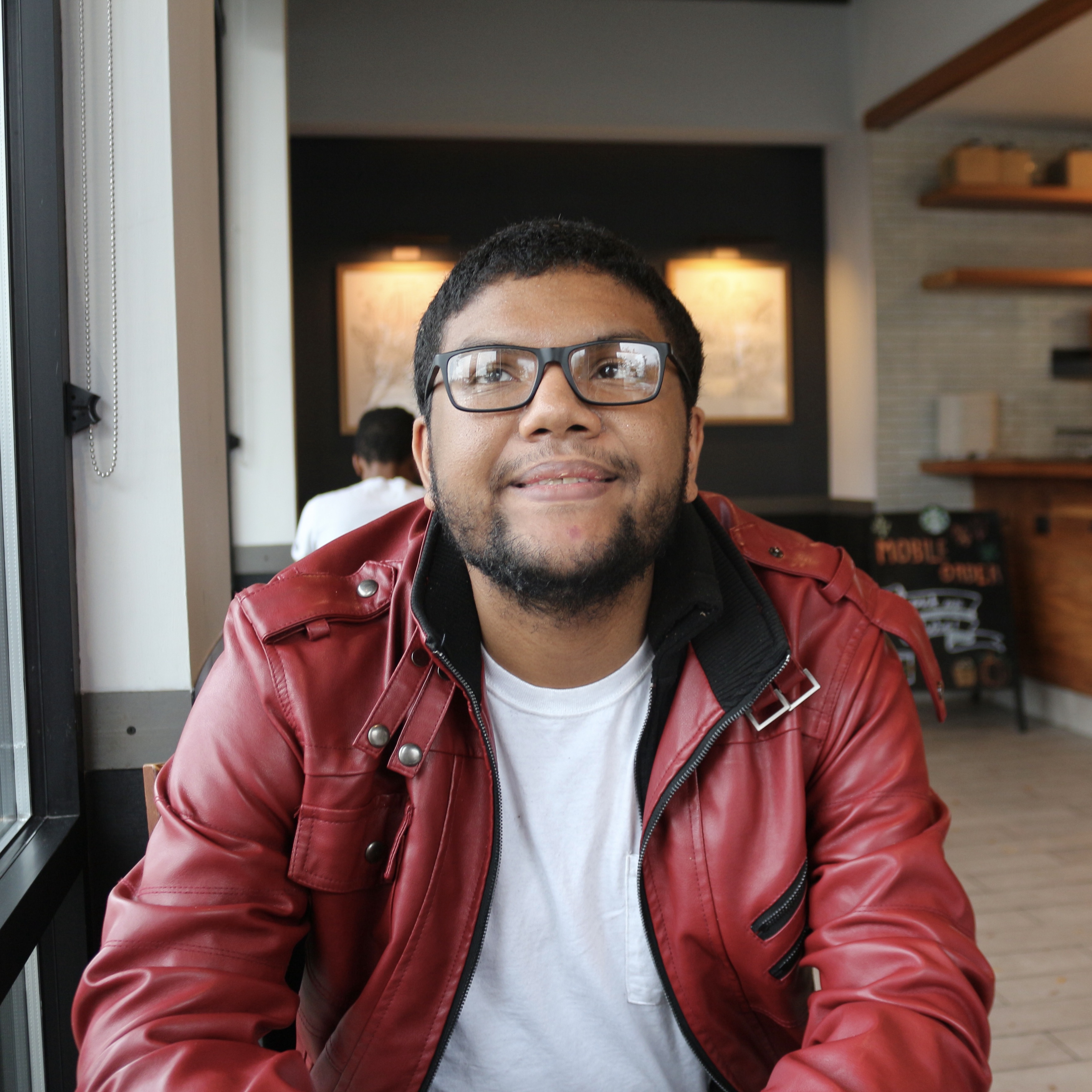 Man smiling for a picture inside