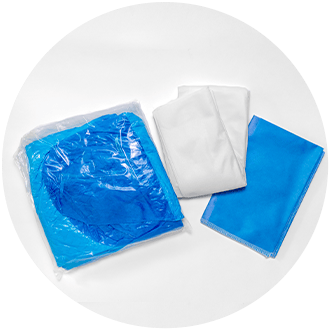 Medical products-hairnet, mask, towel-laying on table.