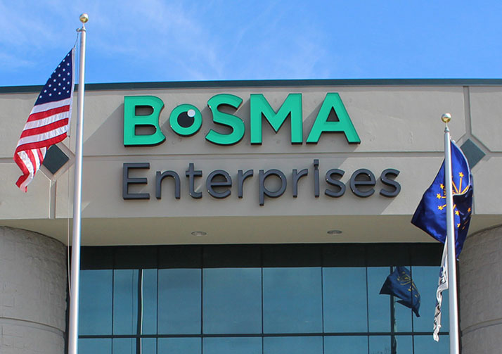 Front of Bosma Enterprises building showing sign, American and State of Indiana flags.
