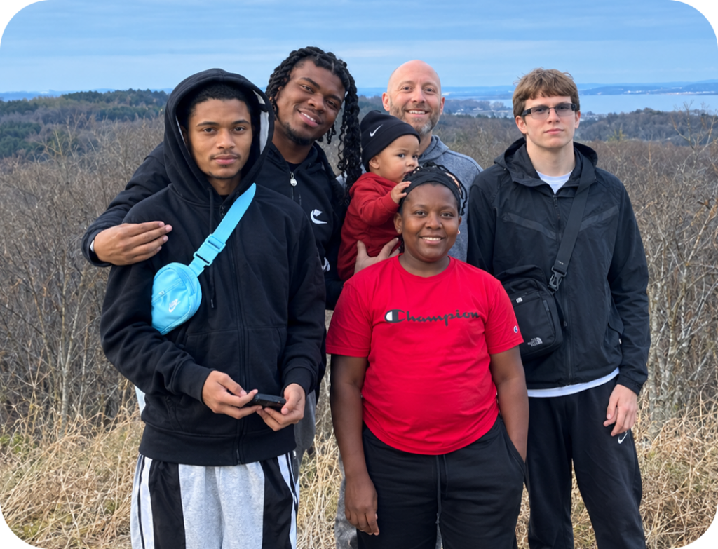 Two men posing with children